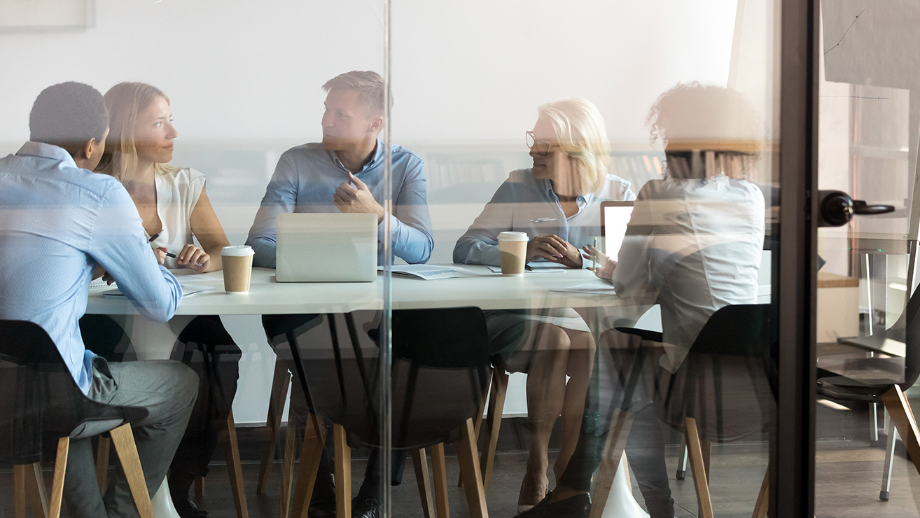 People in a glass walled conference room - Pavion Fire Safety, Integration, and Security